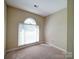 Bright bedroom with a large arched window letting in natural light at 907 Weymouth Dr, Gastonia, NC 28056