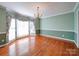 Dining room with hardwood floors, chandelier, and large windows at 907 Weymouth Dr, Gastonia, NC 28056