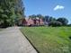 Spacious brick home featuring an attached two-car garage and a well manicured front lawn at 907 Weymouth Dr, Gastonia, NC 28056