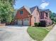 Attached two-car garage with a concrete driveway and manicured landscaping at 907 Weymouth Dr, Gastonia, NC 28056