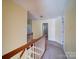 Carpeted hallway with views of adjacent rooms, and the stairs at 907 Weymouth Dr, Gastonia, NC 28056