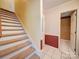 Hallway with carpeted stairs leading to an upstairs area at 907 Weymouth Dr, Gastonia, NC 28056