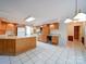 Traditional kitchen with wood cabinets, white appliances, and an island at 907 Weymouth Dr, Gastonia, NC 28056