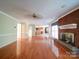 Open-concept living room with hardwood floors, fireplace, and kitchen view at 907 Weymouth Dr, Gastonia, NC 28056
