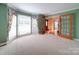 Spacious living room featuring large windows and French doors at 907 Weymouth Dr, Gastonia, NC 28056