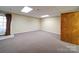 A neutral colored room with wall-to-wall carpet and a door with a carved floral design at 907 Weymouth Dr, Gastonia, NC 28056