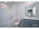 Bathroom featuring a shower and bath combination, quartz countertops and gray cabinets at 1007 Freeman View Dr, Albemarle, NC 28001