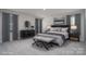 Staged bedroom features modern furniture, gray color palette and natural light from the windows at 1007 Freeman View Dr, Albemarle, NC 28001