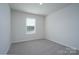 Bright bedroom showing a window with blinds and neutral carpet creating a blank canvas for personal touches at 1007 Freeman View Dr, Albemarle, NC 28001