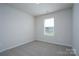 Bright, airy bedroom with a window and neutral carpet providing ample space for relaxation and personalization at 1007 Freeman View Dr, Albemarle, NC 28001