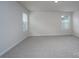 Bedroom featuring two windows for natural light and neutral carpet flooring at 1007 Freeman View Dr, Albemarle, NC 28001