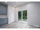 Bright dining area with sliding glass doors leading to the patio and luxury vinyl plank flooring at 1007 Freeman View Dr, Albemarle, NC 28001