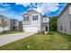 Two-story home featuring a well-manicured lawn, black shutters, and a two-car garage at 1007 Freeman View Dr, Albemarle, NC 28001