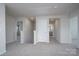 Hallway on second level with neutral carpet and views to a neighboring bedroom and bathroom at 1007 Freeman View Dr, Albemarle, NC 28001