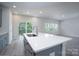 Kitchen island with stainless steel sink, white countertops, and light blue cabinets at 1007 Freeman View Dr, Albemarle, NC 28001