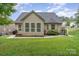 Home's back elevation, showcasing a sunroom and patio at 3150 Helmsley Ct, Concord, NC 28027