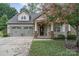 Tan house with a two-car garage and a lovely front yard at 3150 Helmsley Ct, Concord, NC 28027