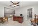 Upstairs home office features a large desk, comfortable chair, and built-in shelving at 3150 Helmsley Ct, Concord, NC 28027