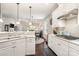 White kitchen with gas cooktop and breakfast bar at 3150 Helmsley Ct, Concord, NC 28027