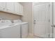 Convenient laundry room with washer, dryer, and cabinets at 3150 Helmsley Ct, Concord, NC 28027