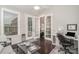 Home office with built-in desk and French doors leading to sunroom at 3150 Helmsley Ct, Concord, NC 28027