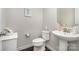 Powder room with pedestal sink and decorative mirror at 3150 Helmsley Ct, Concord, NC 28027