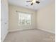 Well-lit bedroom featuring neutral walls and carpet at 4800 Pimlico Ln, Waxhaw, NC 28173