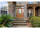 Brick front exterior with wood door and sidelights, stone accents, and landscaping at 4800 Pimlico Ln, Waxhaw, NC 28173