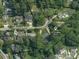 Aerial view of a property at 732 Shawnee Drive, surrounded by lush trees and neighborhood homes at 732 Shawnee Dr, Charlotte, NC 28209