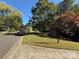 Green lawn on a clear day featuring a real estate sign and a well-manicured lawn at 732 Shawnee Dr, Charlotte, NC 28209