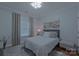 Relaxing bedroom with light gray walls, soft carpet, and decorative windows at 10604 Russet Pl, Charlotte, NC 28227