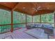 Inviting covered deck with comfortable seating, a ceiling fan, string lights, and views of lush greenery at 10604 Russet Pl, Charlotte, NC 28227