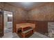 Cozy dining area featuring a built-in booth, classic wood paneling, and a unique brick accent at 10604 Russet Pl, Charlotte, NC 28227