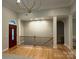 Inviting home entryway with hardwood floors, elegant columns, and a striking front door at 10604 Russet Pl, Charlotte, NC 28227