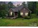 Charming single-story brick home featuring manicured landscaping and a well-maintained lawn at 10604 Russet Pl, Charlotte, NC 28227