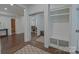 Bright hallway featuring storage, mirror sliding doors, and hardwood floors at 10604 Russet Pl, Charlotte, NC 28227