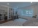 Bright home office featuring custom built-in shelving, a large window and ample space for work or study at 10604 Russet Pl, Charlotte, NC 28227