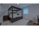 Elegant main bedroom showcases a stunning four-poster bed, creating a luxurious and inviting retreat at 10604 Russet Pl, Charlotte, NC 28227