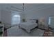 Serene main bedroom with tray ceiling, soft lighting, and a calming color palette at 10604 Russet Pl, Charlotte, NC 28227