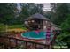 Inviting in-ground pool with a wooden deck and lounge chairs, perfect for outdoor relaxation and entertainment at 10604 Russet Pl, Charlotte, NC 28227