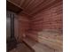 Inside the sauna showcases a traditional wooden bench, stove with rocks and natural wood walls at 10604 Russet Pl, Charlotte, NC 28227