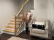 Stylish staircase with wooden steps, black metal railings, and modern design, complemented by elegant decor at 10604 Russet Pl, Charlotte, NC 28227