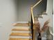 Chic staircase featuring wooden steps, black metal railings and decor, enhancing the home's modern appeal at 10604 Russet Pl, Charlotte, NC 28227