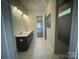 Elegant bathroom featuring a double vanity and tiled shower with a window at 8605 Carly Ln, Mint Hill, NC 28227