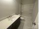 This bathroom has updated cabinets, a white countertop and a shower and tub combo at 8605 Carly Ln, Mint Hill, NC 28227