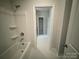 Well-lit bathroom featuring a tub-shower combo and an open view to a linen closet at 8605 Carly Ln, Mint Hill, NC 28227