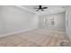 Large bedroom with a tray ceiling, carpeted floors, and natural light at 8605 Carly Ln, Mint Hill, NC 28227