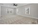 Spacious carpeted bedroom with ample natural light and a ceiling fan at 8605 Carly Ln, Mint Hill, NC 28227