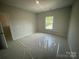 Inviting bedroom features neutral walls and a window providing a view of the outdoors at 8605 Carly Ln, Mint Hill, NC 28227