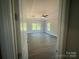 Bright bedroom featuring tray ceilings, a fan, and hardwood floors at 8605 Carly Ln, Mint Hill, NC 28227